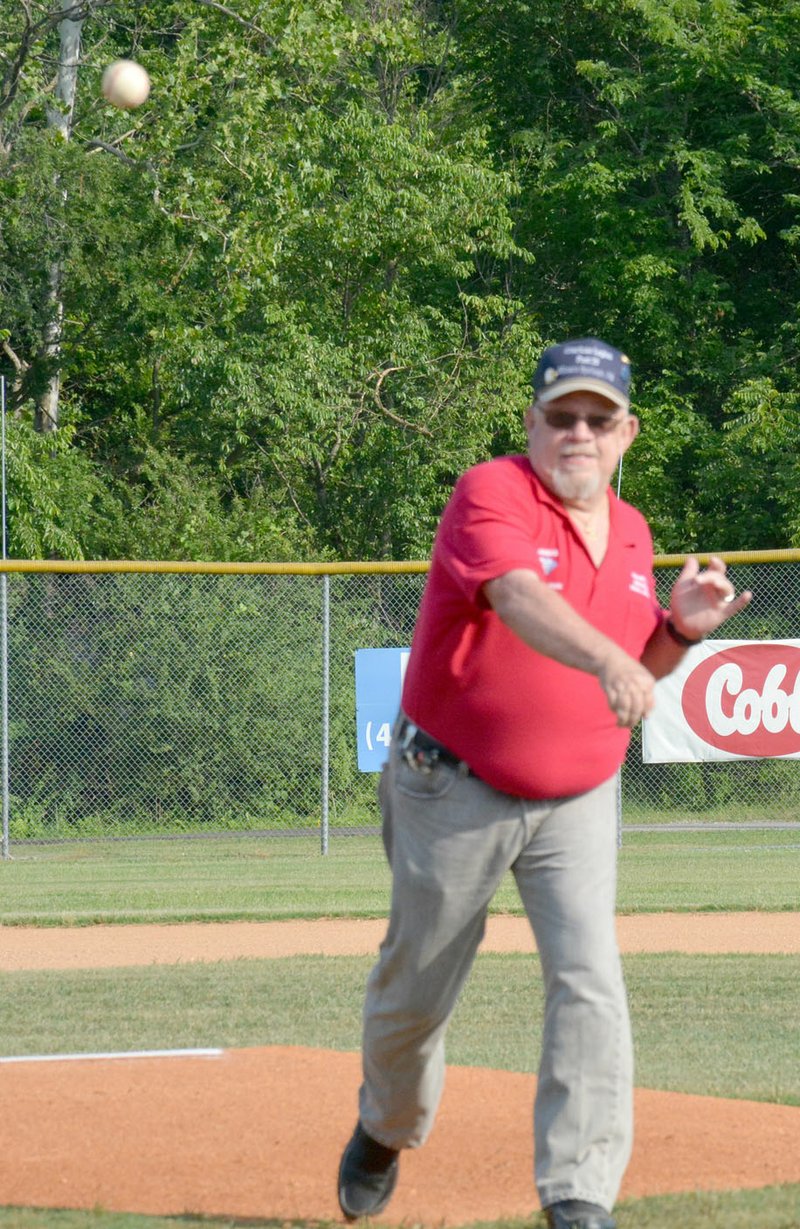 Graham Thomas/Siloam Sunday American Legion Siloam Post 29 commander Jim Wilbanks throws out the ceremonial first pitch prior to Wednesday's doubleheader at James Butts Baseball Park.