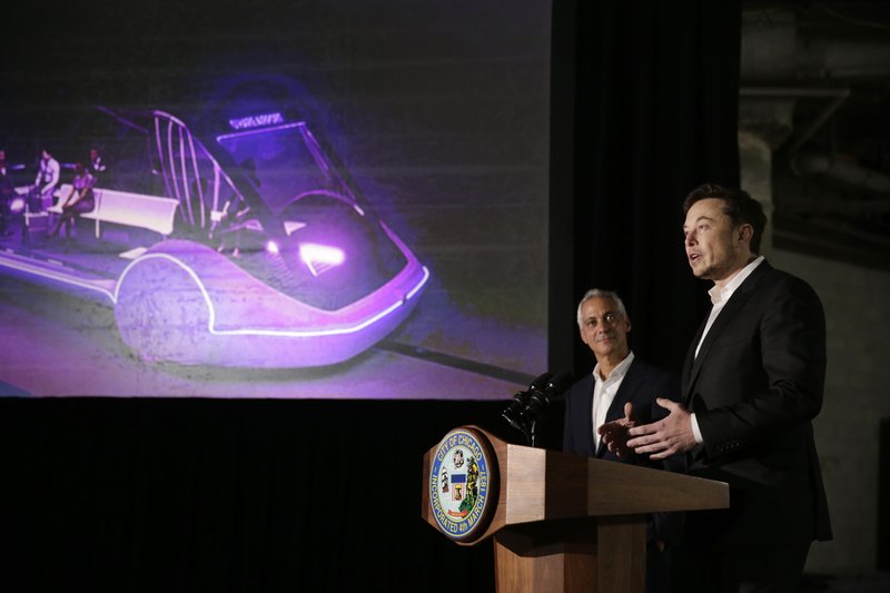 Chicago Mayor Rahm Emanuel, left, listens as Tesla CEO and founder of the Boring Company Elon Musk, right, speaks at a news conference Thursday, June 14, 2018, in Chicago. The Boring Company has been selected to build a high-speed underground transportation system that it says will whisk passengers from downtown Chicago to O'Hare International Airport in mere minutes. (AP Photo/Kiichiro Sato)