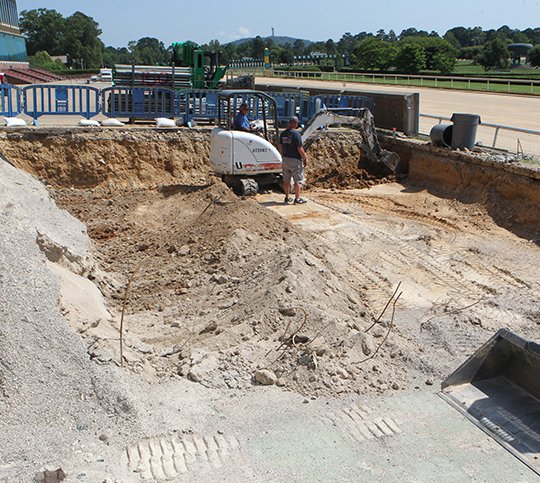 The Sentinel-Record/Richard Rasmussen TAKING SHAPE: Construction workers on Friday carve out an area that will become the new winner's circle at Oaklawn Park. This and other projects are expected to be completed before horses arrive in November.