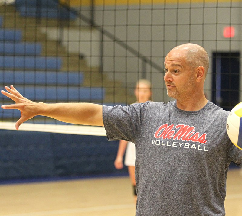 The Sentinel-Record/Richard Rasmussen REBEL TRAINING: Ole Miss head volleyball coach Steven McRoberts runs a volleyball camp at Lakeside Athletic Complex Thursday. McRoberts worked with 20 Ram volleyball players at the camp, using different techniques to help improve their skills.