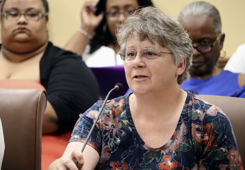 Debbie Holt, of Centerton, Ark., tells the prisons subcommittee of the Arkansas Legislative Council in Little Rock on Thursday, June 14, 2018, that two incarcerated sons have received poor medical care behind bars. After hearing similar complaints from others, Correction Department officials said there is room for improvement but that, at times, inmates don't tell the truth. (AP Photo/Kelly P. Kissel)