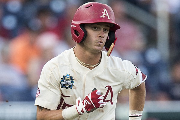 Arkansas third baseman Casey Martin runs toward first base after hitting an RBI single during the sixth inning of a College World Series game against Texas on Sunday, June 17, 2018, in Fayetteville. 