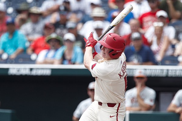 Arkansas outfielder Heston Kjerstad hits an RBI single during the first inning of a College World Series game against Texas on Sunday, June 17, 2018, in Omaha, Neb.