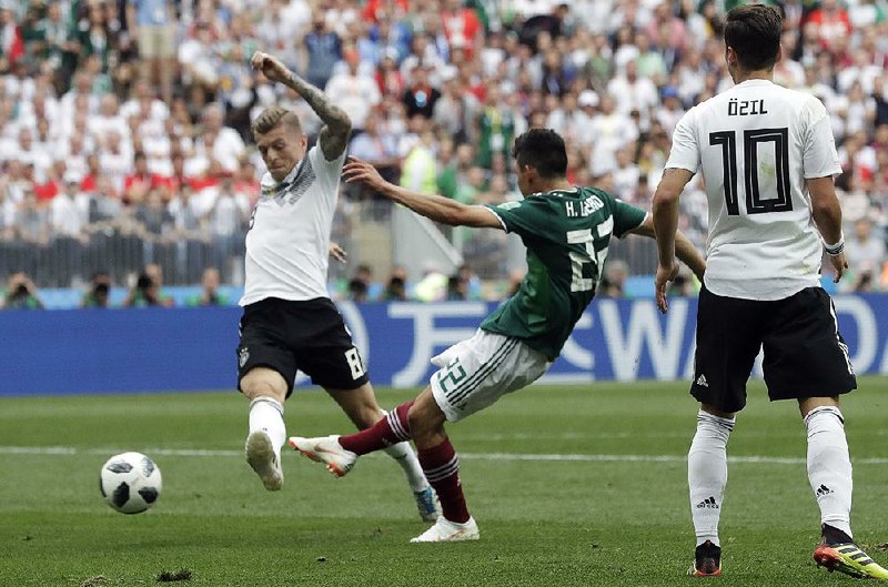 Mexico’s Hirving Lozano (right) scores past Germany’s Toni Kroos during Sunday’s World Cup match at Luzhniki Stadium in Moscow. It was Mexico’s first victory over Germany in a competitive match. 