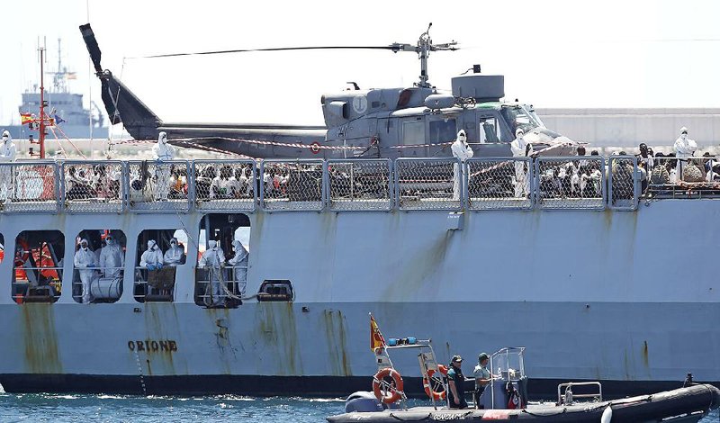 Migrants stand on board the Italian naval vessel Orione as it arrives at the eastern port of Valencia, Spain, on Sunday.  
