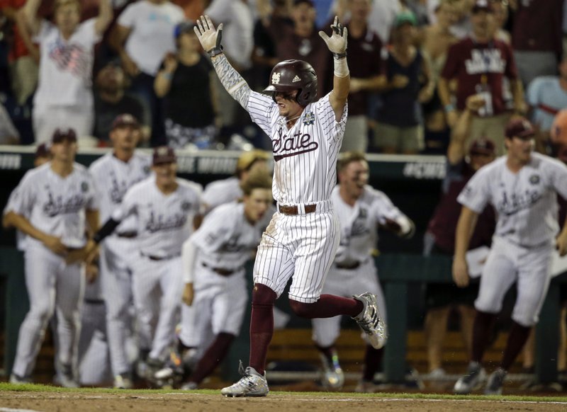 Mississippi State's Hunter Stovall, center, celebrates as he runs to home plate for the winning run against Washington on a single by Luke Alexander in the ninth inning of an NCAA College World Series baseball game in Omaha, Neb., Saturday, June 16, 2018. (AP Photo/Nati Harnik)