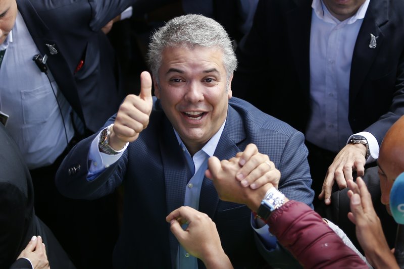 Ivan Duque, candidate of the Democratic Center party, greets supporters after voting during a presidential runoff election in Bogota, Colombia, Sunday, June 17, 2018. Voters will choose between Duque and Gustavo Petro, a former leftist rebel and ex-Bogota mayor. (AP Photo/Fernando Vergara)