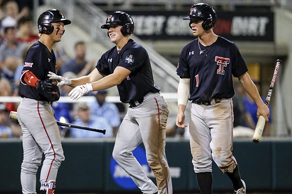 Texas Tech's Cody Farhat, right, and Braxton Fulford, center, are congratulated by Brian Klein after they scored against Florida on a two-run single by Gabe Holt in the fifth inning of an NCAA College World Series baseball game in Omaha, Neb., Sunday, June 17, 2018. (AP Photo/Nati Harnik)

