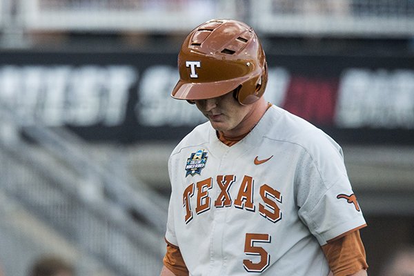 Ryan Reynolds of Texas walks off after striking out in the 7th inning against Arkansas Sunday, June 17, 2018, during game three of the NCAA Men's College World Series at TD Ameritrade Park in Omaha.