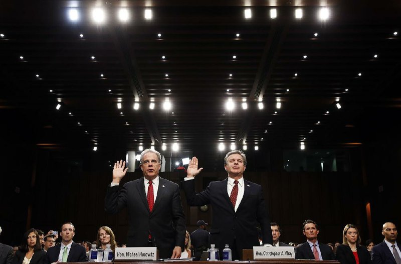 Department of Justice Inspector General Michael Horowitz (left) and FBI Director Christopher Wray are sworn in Monday on Capitol Hill at a hearing by the Senate Judiciary Committee to examine Horowitz’s report of the FBI’s investigation of Hillary Clinton’s use of a private email server. 