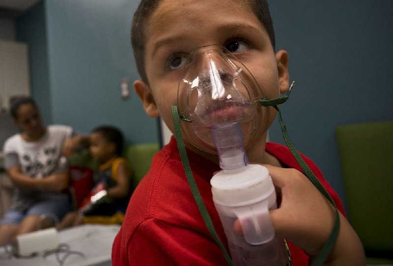 Yahir Garcia receives one of his two daily treatments for asthma at a medical center in San Juan, Puerto Rico, in May. 