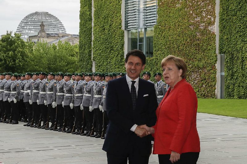 German Chancellor Angela Merkel welcomes Italian Prime Minister Giuseppe Conte for talks at the chancellery in Berlin on Monday.  