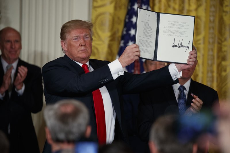 The Associated Press SPACE FORCE: President Donald Trump shows off a "Space Policy Directive" after signing it during a meeting of the National Space Council in the East Room of the White House, Monday in Washington.