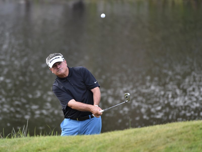 FILE - In this Aug. 6, 2017, file photo, Paul Goydos hits his way out of trouble on the 16th hole during the championship round of the 3M Championship golf tournament in Blaine, Minn. Minnesota has hosted the 3M Championship on the PGA Tour Champions since 1993, and the final event for seniors will be Aug. 3-5 with Goydos as the defending champion. (AP Photo/John Autey, File)