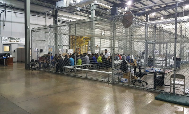 The Associated Press SITTING IN CAGES: In this photo provided by U.S. Customs and Border Protection, people who've been taken into custody related to cases of illegal entry into the United States, sit in one of the cages at a facility in McAllen, Texas, Sunday.