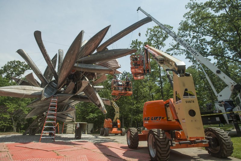 NWA Democrat-Gazette/BEN GOFF @NWABENGOFF A crew installs the sculpture 'Monochrome II' by Nancy Rubins June 7 on the North Forest Trail at Crystal Bridges Museum of American Art. The sculpture is fabricated from aluminum canoes and jon boats.