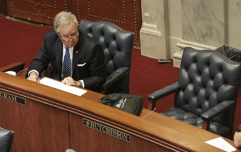 Sen. Keith Ingram, D-West Memphis, on Tuesday sits next to the empty seat of Sen. Jeremy Hutchinson, R-Little Rock, as colleagues discuss new ethics rules for that body of the Legislature.