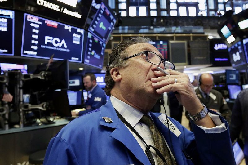 Trader Steven Kaplan works Tuesday on the floor of the New York Stock Exchange, where industrial and tech stocks fell on fears of an all-out trade war between the United States and China.