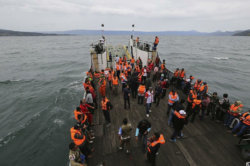 An Indonesian search and rescue team on Tuesday searches near where a ferry sank Monday in Lake Toba, North Sumatra.