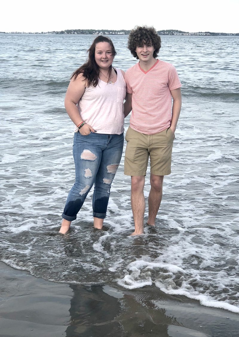 SUBMITTED With the city of Boston and Boston Harbor as a backdrop, Decatur natives Cameron Shaffer (left) and brother Ryan take a quiet walk along a beach near Quincy, Mass., in late May 2018. After living nine months in the Medford-Boston area, Ryan Shaffer returned to Decatur to spend his summer months with his family and friends.