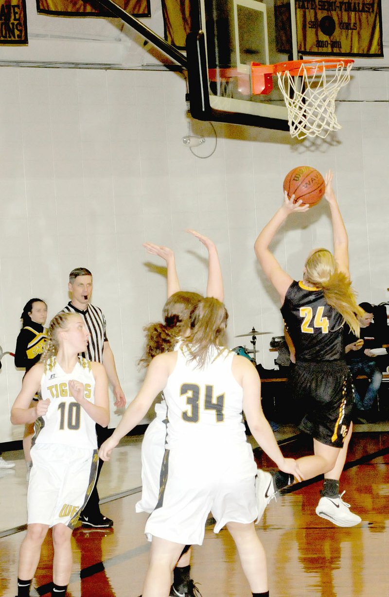 MARK HUMPHREY ENTERPRISE-LEADER Prairie Grove 2018 graduate, Sarah James Stone, shown making an athletic move to score a twisting layup against West Fork, is the Enterprise-Leader's Female Athlete-of-the-Year for school year 2017-2018 at Prairie Grove.