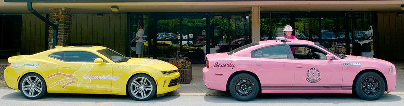 Keith Bryant/The Weekly Vista Capt. Seth Kallick with the Bella Vista Fire Department stands with a Pink Heals vehicle parked next to a Cancer Challenge vehicle outside Riordan Hall. While the groups have no formal affiliation, Kallick said he came out to show support for the event.