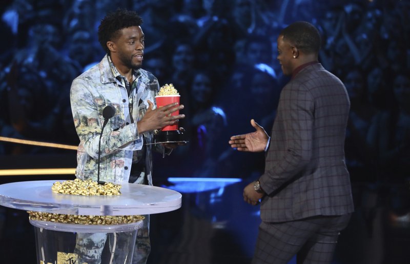 In this Saturday, June 16, 2018, photo, Chadwick Boseman, left, gives his best hero award for his role in "Black Panther" to James Shaw Jr., who is credited with saving lives during a shooting at a Waffle House in Antioch, Tenn., at the MTV Movie and TV Awards at the Barker Hangar in Santa Monica, Calif. (Photo by Matt Sayles/Invision/AP)
