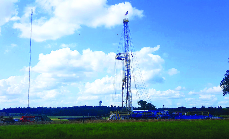 Rig workers begin drilling for oil in the fields near U.S. Hwy. 82, across from Southern Arkansas University’s alumni complex in Magnolia.