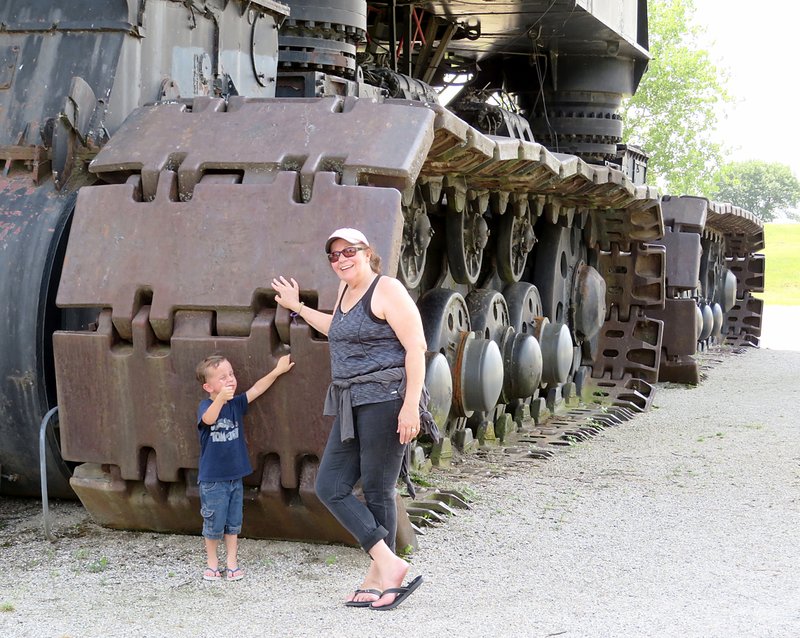 The enormity of Big Brutus, an electric shovel in West Mineral, Kan., can be seen by its tracks behind my wife and grandson.