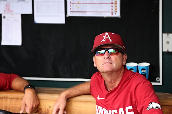 Arkansas coach Dave Van Horn watches from the dugout during a rain delay prior to a College World Series game against Texas Tech on Wednesday, June 20, 2018, in Omaha, Neb.