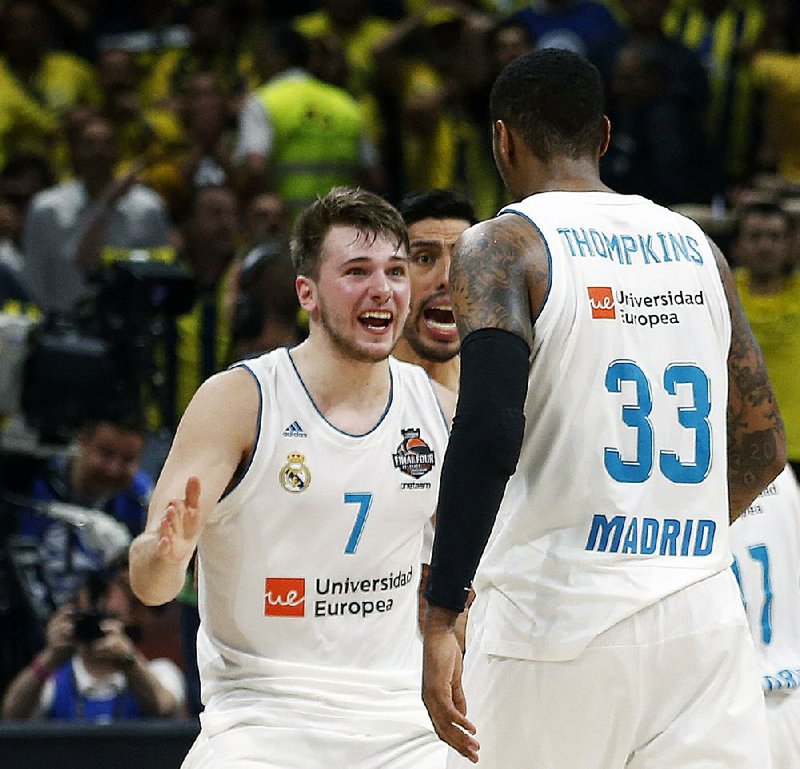 In this May 20, 2018, file photo, Real Madrid's Luka Doncic (7) reacts with teammate Trey Thompkins after winning their Final Four Euroleague final basketball match against Fenerbahce, in Belgrade, Serbia. The Slovenian guard heads the list of international players expected to be selected in the NBA draft. 