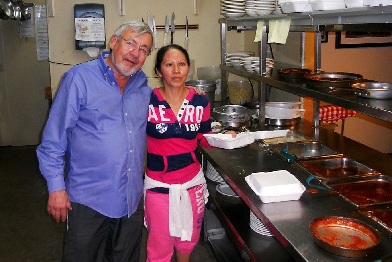 Ken Shivey, with employee Lourdes Melo in the Villa kitchen on West Markham Street in 2012, is working with the owners of Pasta J’s in west Little Rock to turn it into The Villa West. 