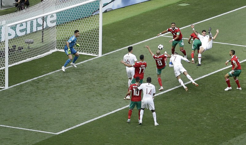 The Associated Press A HEAD ABOVE: Portugal's Cristiano Ronaldo, with blue captain's armband, heads the ball to score the opening goal during the Group B match between Portugal and Morocco at the 2018 World Cup in Luzhniki Stadium in Moscow, Russia, Wednesday.