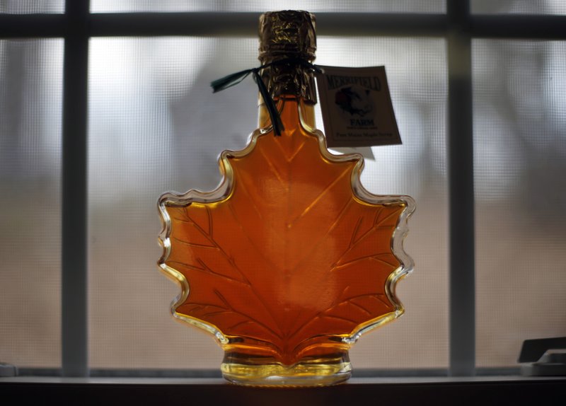 FILE- In this March 9, 2016, file photo, a bottle of maple syrup are displayed at the Merrifield Farm and Sugar Shack in Gorham, Maine. The U.S. Food and Drug Administration is reconsidering its plan to label pure maple syrup and honey as containing added sugars. (AP Photo/Robert F. Bukaty, File)