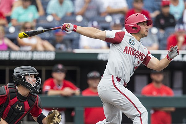 Dominic Fletcher, Arkansas center fielder, hits a 2 RBI double in the 1st inning as Braxton Fulford catches for Texas Tech Wednesday, June 20, 2018 in game eight of the NCAA Men's College World Series between at TD Ameritrade Park in Omaha.