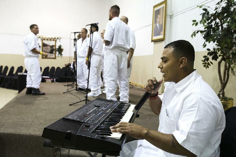 Maurice Castillo plays the keyboards with a combined choir made up of inmates at St. Paul Missionary Baptist Church for Father’s Day on Sunday in Houston.  