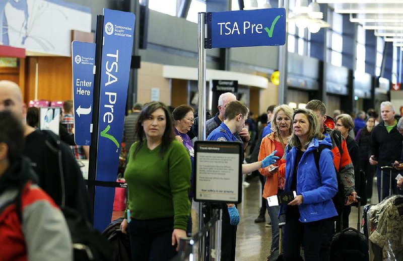 Travelers line up to go through the TSA PreCheck lanes at the Seattle-Tacoma International Airport. AP file photo
