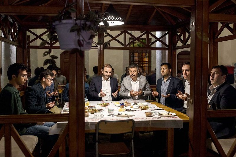 Members of the Imam Hatip Graduates’ Association pray during Iftar in Istanbul.  