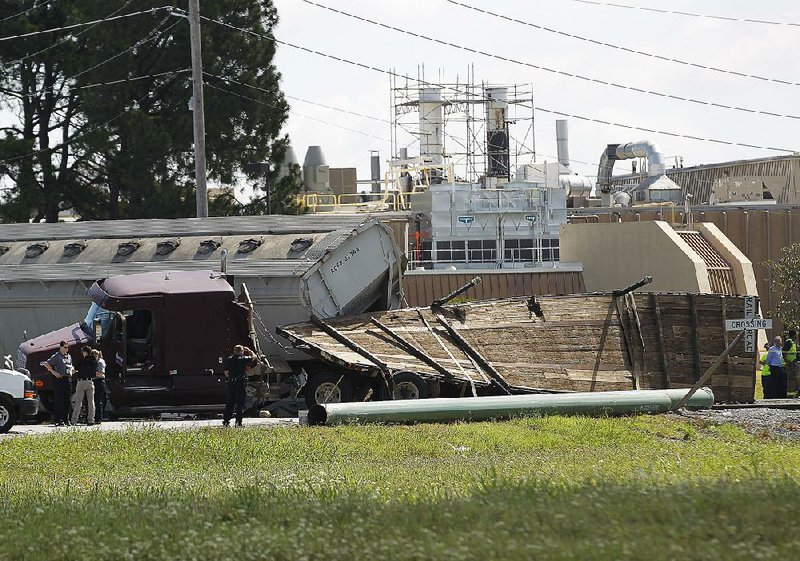 Little Rock police investigate after a train crashed into an 18-wheeler crossing the railroad tracks Thursday on Frazier Pike Road in Little Rock. More photos are available at arkansasonline.com/galleries.  