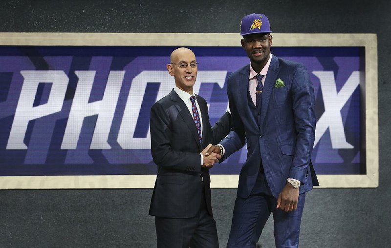 Deandre Ayton (right) is congratulated by NBA Commissioner Adam Silver after being taken by the Phoenix Suns with the first pick of the NBA Draft on Thursday night at the Barclays Center in Brooklyn. 