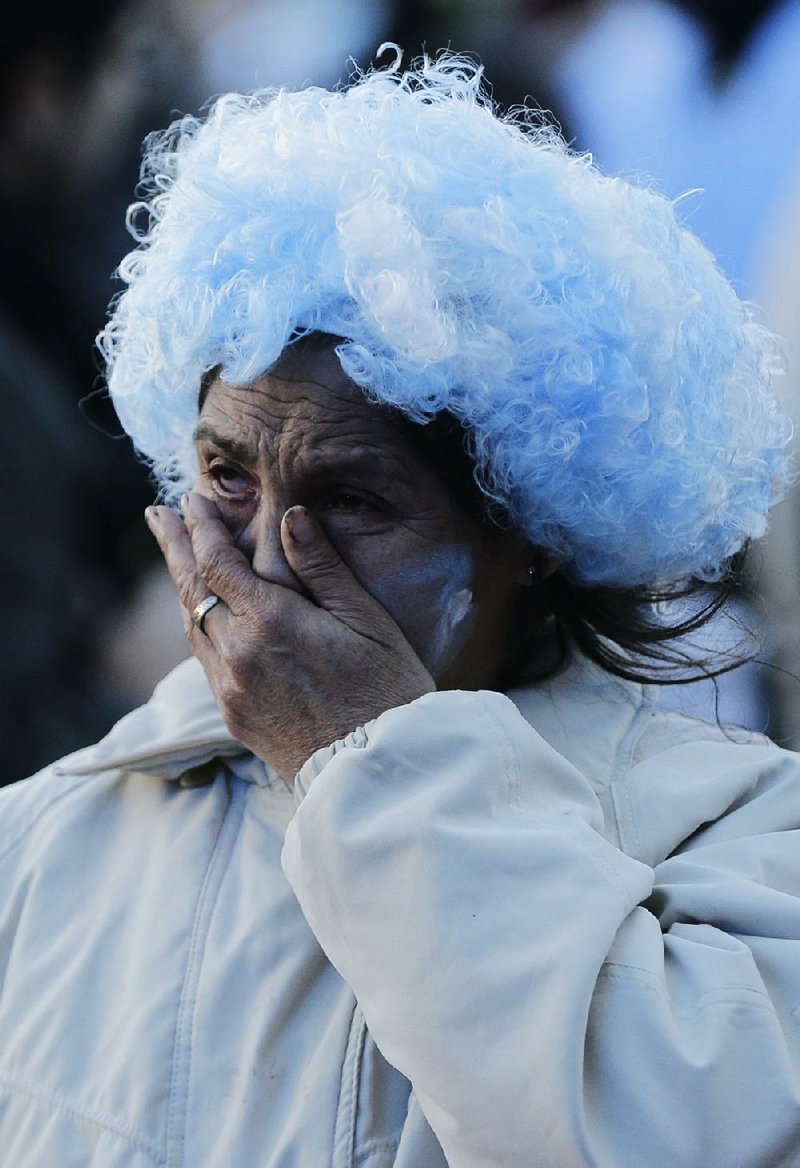 An Argentina fan cries in Buenos Aries after a televised broadcast of Argentina’s World Cup loss to Croatia on Thursday. 