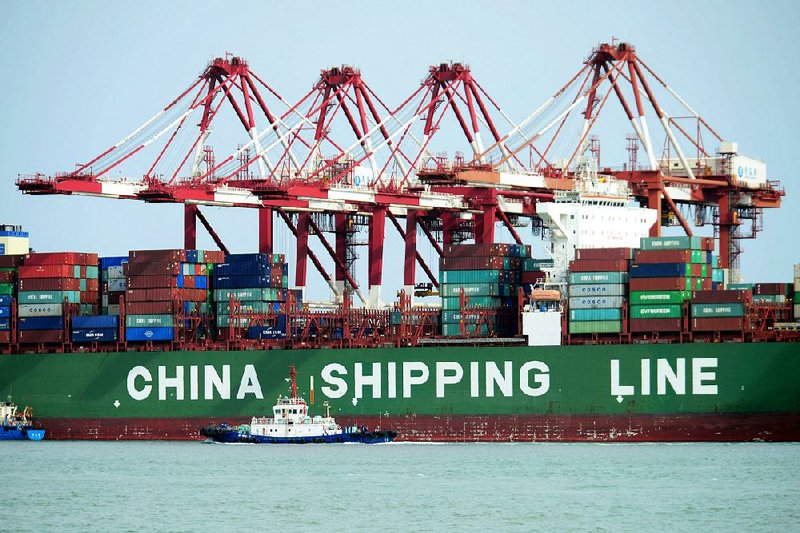 A container ship sits docked this spring in Qingdao, China. The rhetoric between the U.S. and China over trade tariffs is intensifying. 