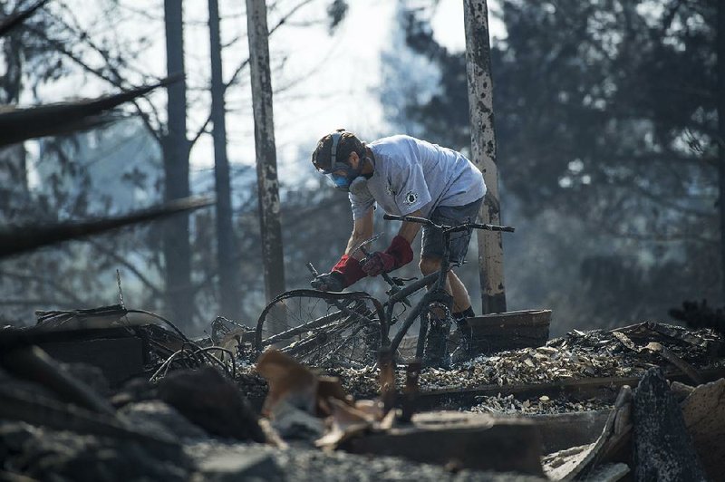 A resident searches the rubble after a wildfire destroyed his home in Napa, Calif., last October. The Pacific Gas & Electric Co. power lines are being blamed for sparking some of last fall’s blazes in the state. 