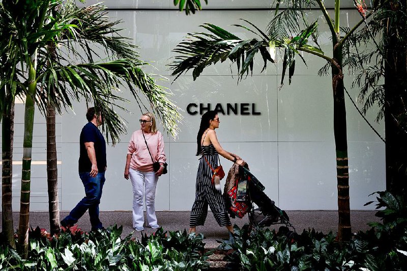 Shoppers pass in front of a Chanel store in Miami early this year. The French fashion house published financial results Thursday for the first time in its 108-year history. 