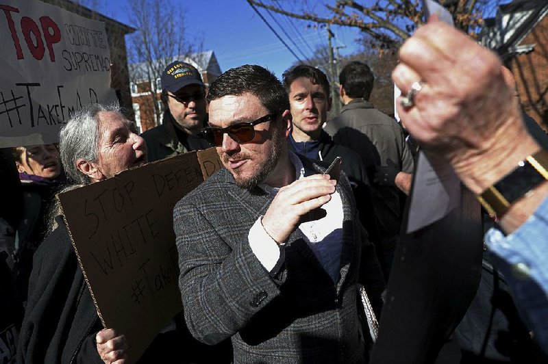 Jason Kessler pushes through a crowd of protesters at the Charlottesville, Va., courthouse for a hearing in February. Kessler’s application for a permit to hold a “white civil rights” rally near the White House has been preliminarily approved by the National Park Service.  