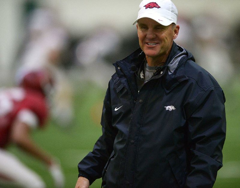 Arkansas coach Chad Morris speaks with players Wednesday, March 28, 2018, during practice at the university's practice facility on campus in Fayetteville. 