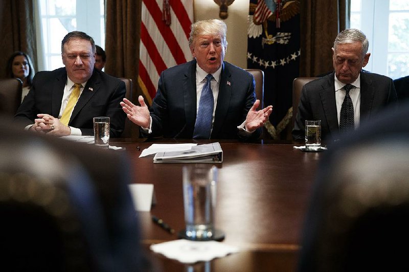 President Donald Trump holds a Cabinet meeting Thursday at which an overhaul of the federal government was proposed. He is flanked by Secretary of State Mike Pompeo (left) and Defense Secretary James Mattis.  