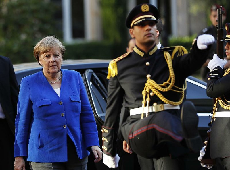 German Chancellor Angela Merkel reviews an honor guard Thursday at the Lebanese government palace in Beirut.  