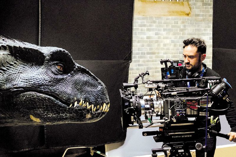 Jurassic World: Fallen Kingdom director J.a. Bayona gets up close and personal with the head of an indoraptor on the set of the fifth installment of the Jurassic Park movies. 
