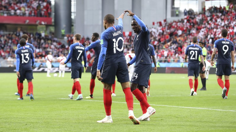 The Associated Press LES BLEUS THROUGH: France's Blaise Matuidi, right, celebrates with Kylian Mbappe after a 1-0 victory over Peru Thursday in Group C of the 2018 FIFA World Cup in Yekaterinburg, Russia.